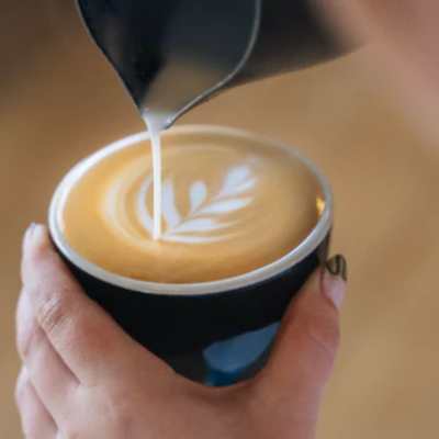 An image of someone pouring coffee