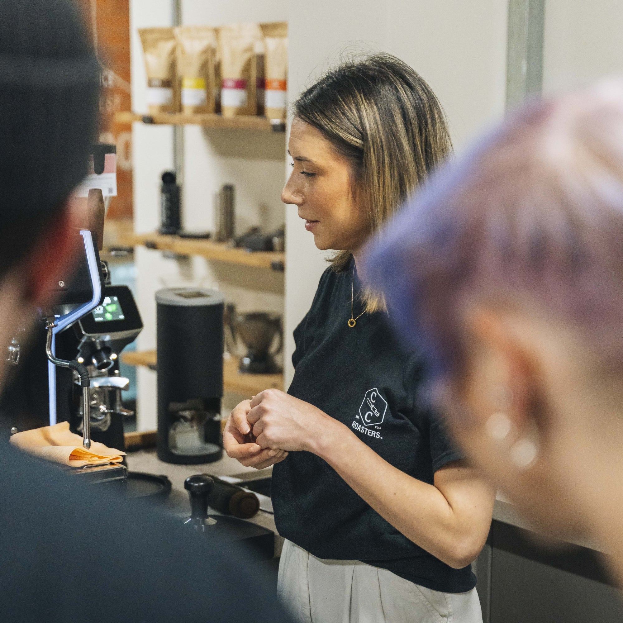 An image of a woman brewing coffee