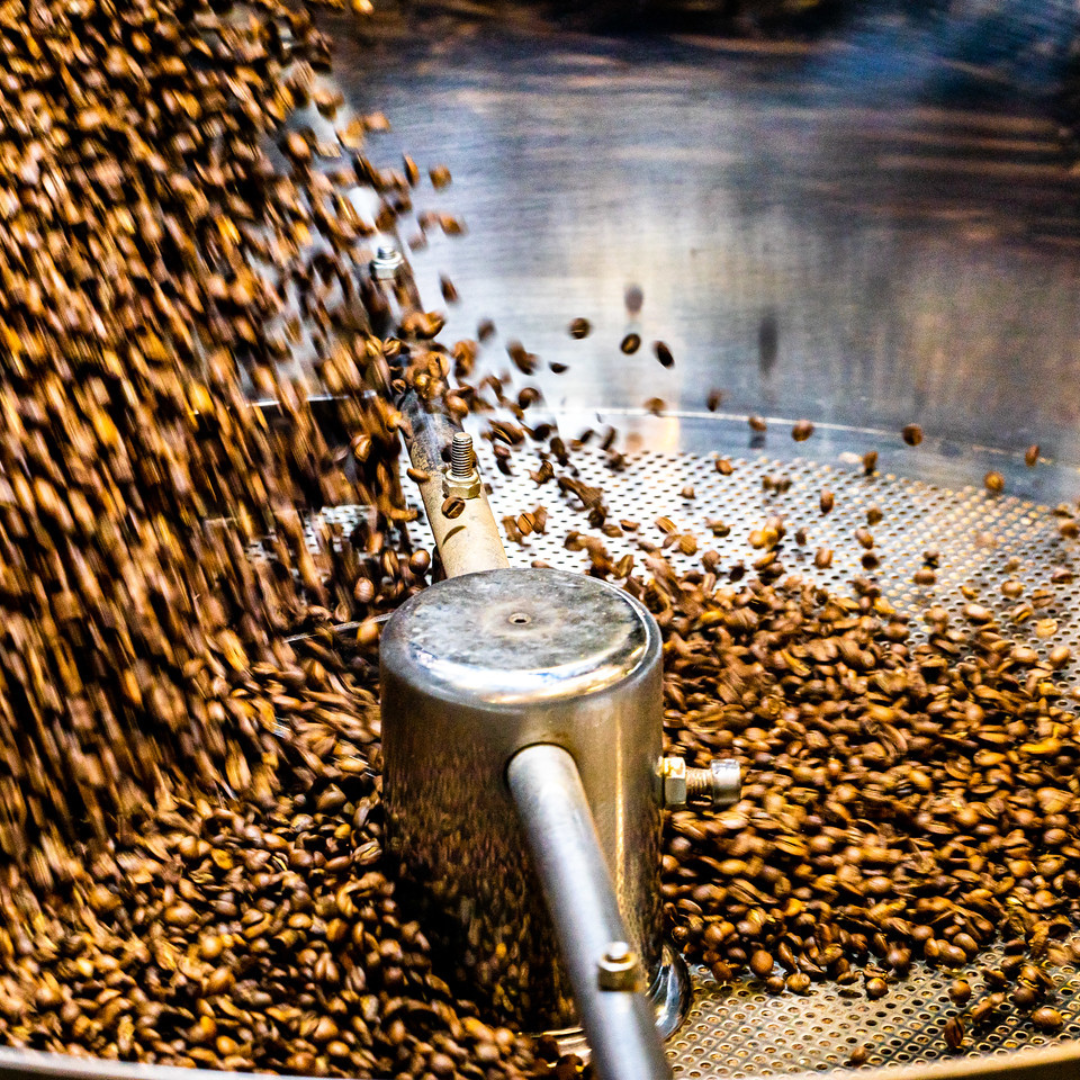 An image of coffee beans being mixed in a machine